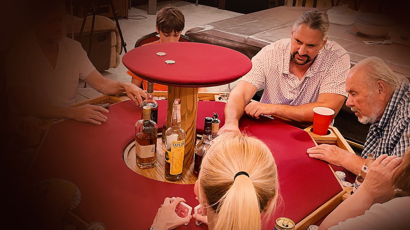 Players around the Azoth table, the bar risen at its center with bottles within reach