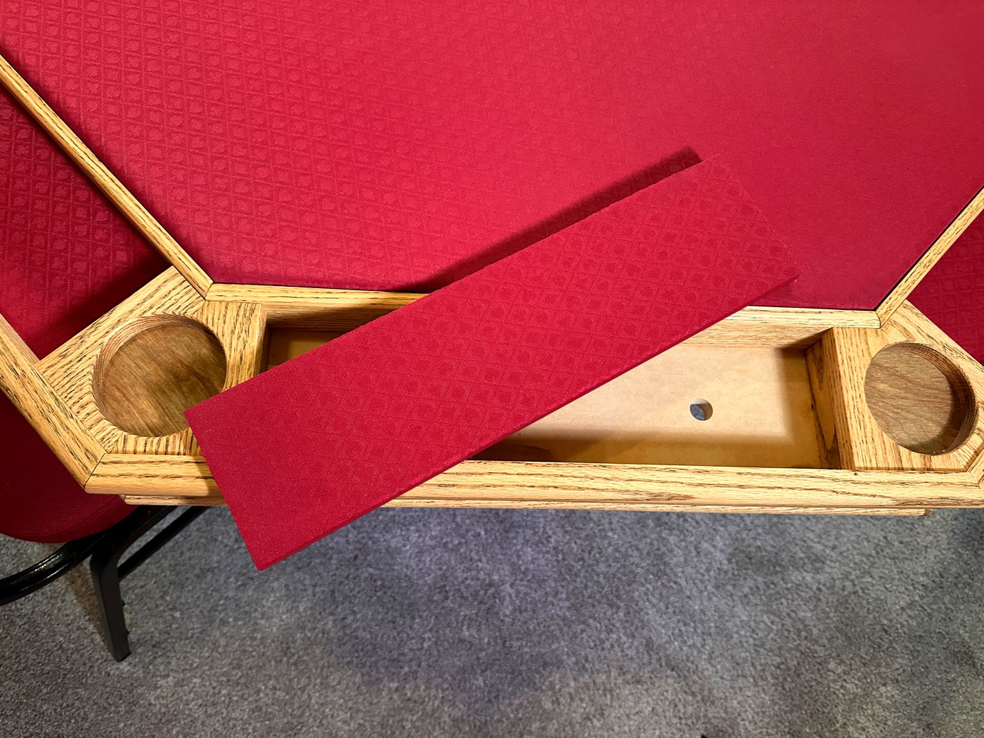 A chip tray insert lifted out of the rail for cleaning