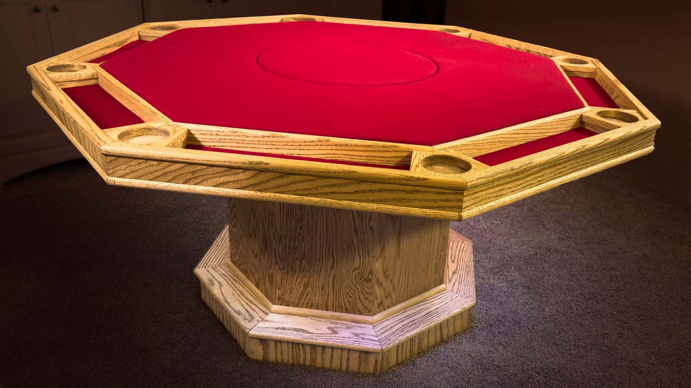 The Azoth table closed — a three-quarter view of the solid oak octagon and pedestal base